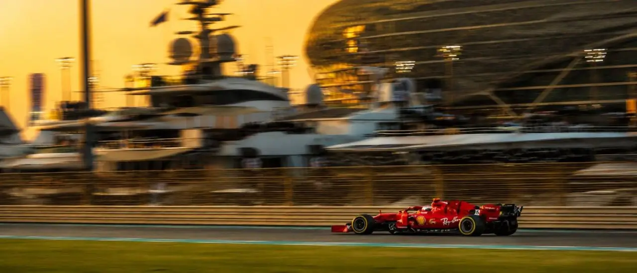 A Formula 1 car passing the marina at golden hour