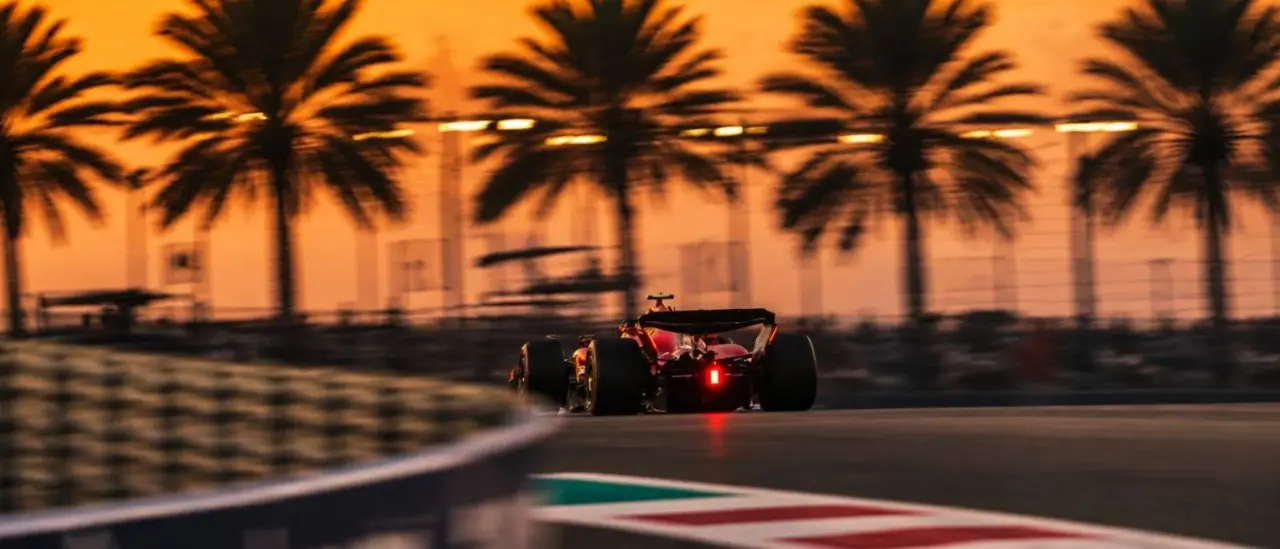 A Formula 1 car in motion under floodlights